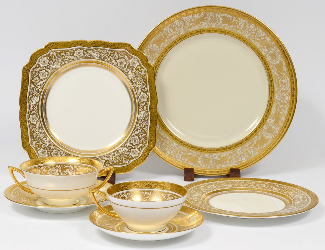 FIFTY-FIVE PIECE MINTONS PORCELAIN PART DINNER SERVICE: English. 20th Century. In the "Porcelain Ball" pattern. Comprising: Four dinner plates, six salad plates, ten dessert plates, seven cake plates, two cream soup cups and eleven saucers, two cups and fi