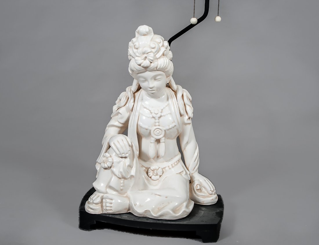 BLANC DE CHINE CERAMIC FIGURE OF GUANYIN: Italian. Modeled in a seated position. Height 22". With a wood lamp base. (100/150)
