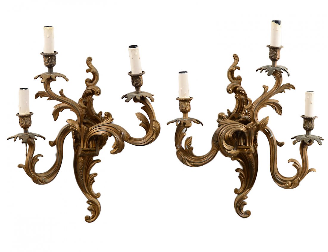 PAIR OF LOUIS XVI STYLE GILT BRONZE SCONCES: Each leaf shaped back plate issuing branches ending in floral nozzles. Height 18 1/4". (250/350)