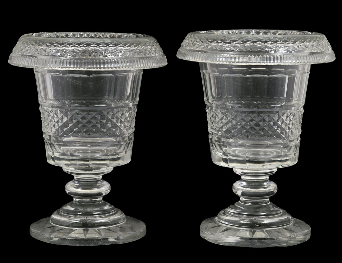 PAIR OF REGENCY STYLE CUT GLASS URNS: English. Circa 1900. Each cut with diamonds. Height 7 3/4". (Cond: chip to one base) (300/400)