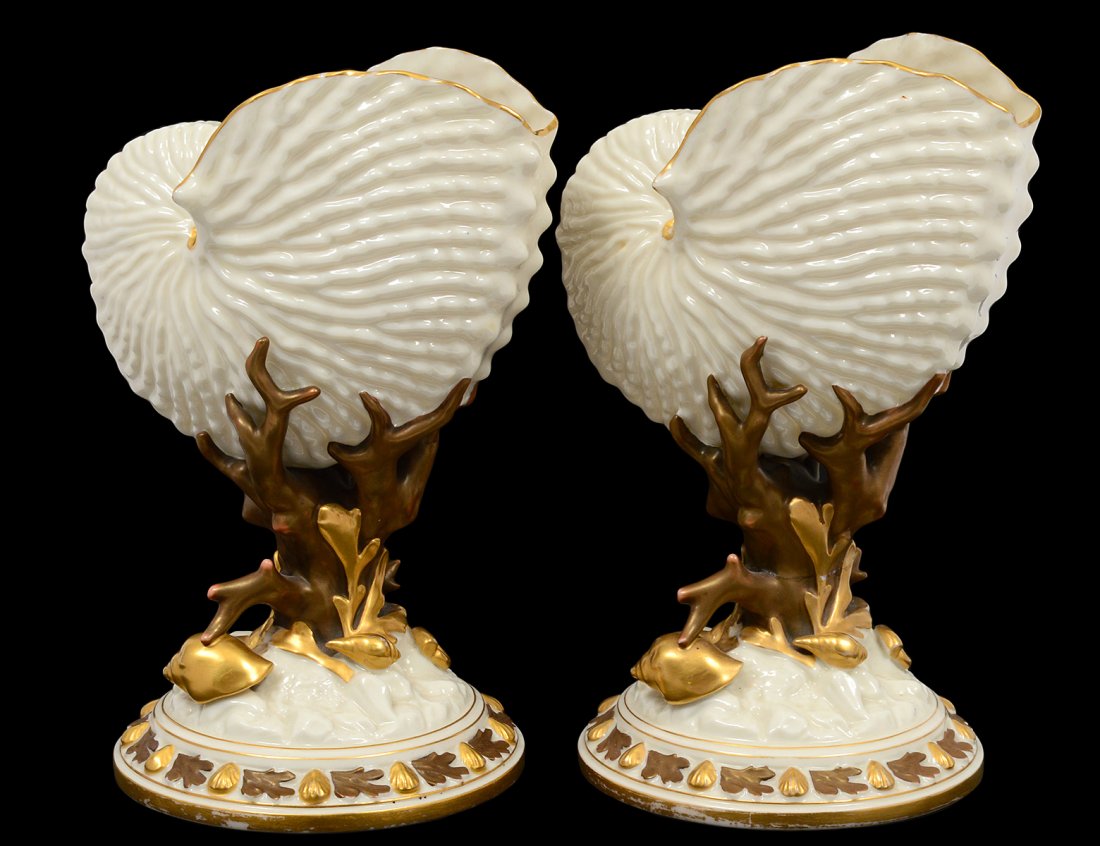 PAIR OF ROYAL WORCESTER PORCELAIN SHELLS: English. Date mark for 1883. Each shell cradled by coral, on a domical base. Height 8 1/2". (700/900)