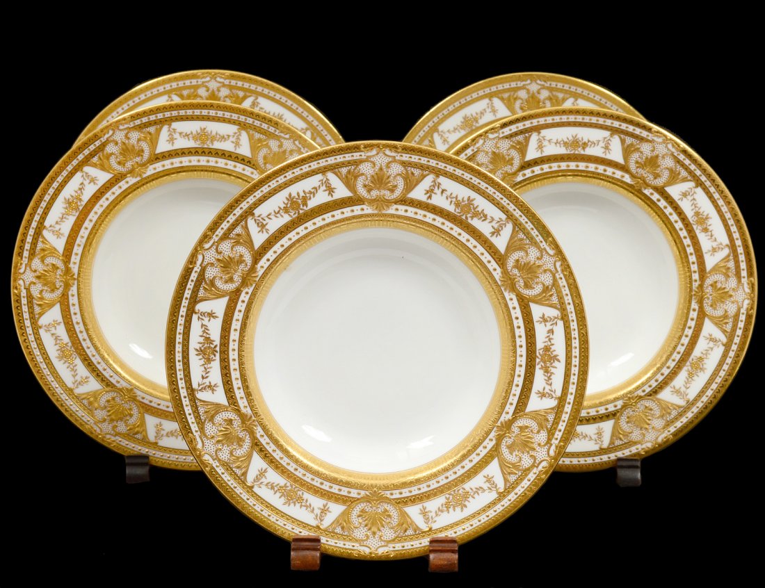 SET OF FIVE MINTONS PORCELAIN SOUP PLATES: English. Date mark probably 1890. Printed and impressed factory marks. Each heavily encrusted with a gold shoulder. Diameter 9". (200/300) Retailed by Tiffany & Co., N.Y.