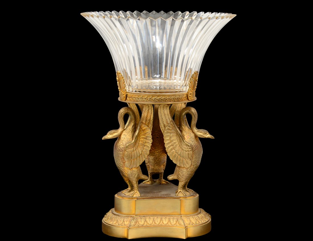 EMPIRE STYLE GILT BRONZE AND GLASS CENTERPIECE: The bowl supported by three swans. Height 12 1/4". Diameter 8 1/2". (300/400)
