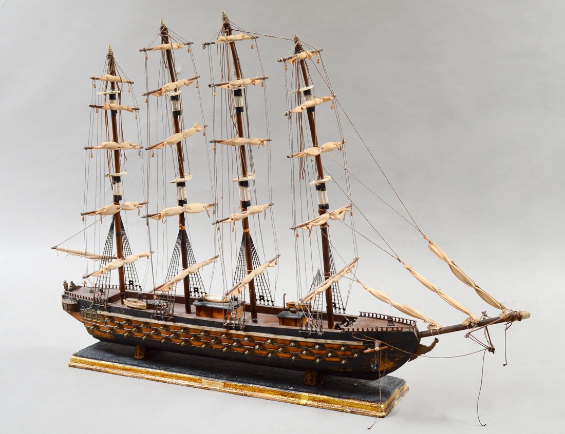 SHIP'S MODEL OF A FOUR MASTED MAN-O-WAR: With full riggings, life boats, canons, anchor and chains. Height 28". Length 41 1/2". (250/350)