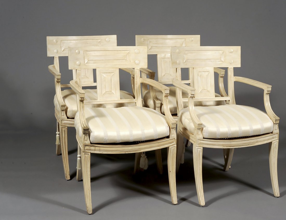 SET OF FOUR PAINTED ARM CHAIRS: American. Michael Taylor Design, California. Each with cane seat and loose cushion. (600/800)