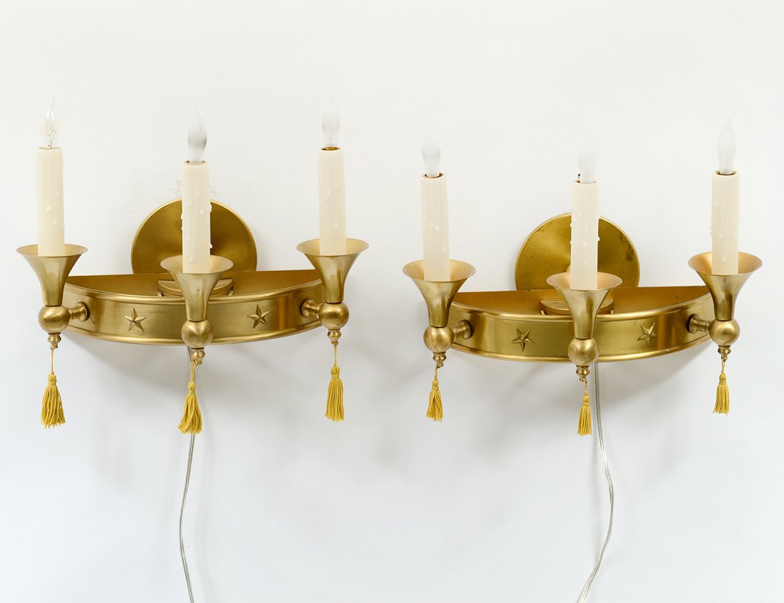 PAIR OF MID-CENTURY BRASS THREE LIGHT SCONCES: Each of demi-lune shape with star appliques. Height 8 1/4". (300/400)