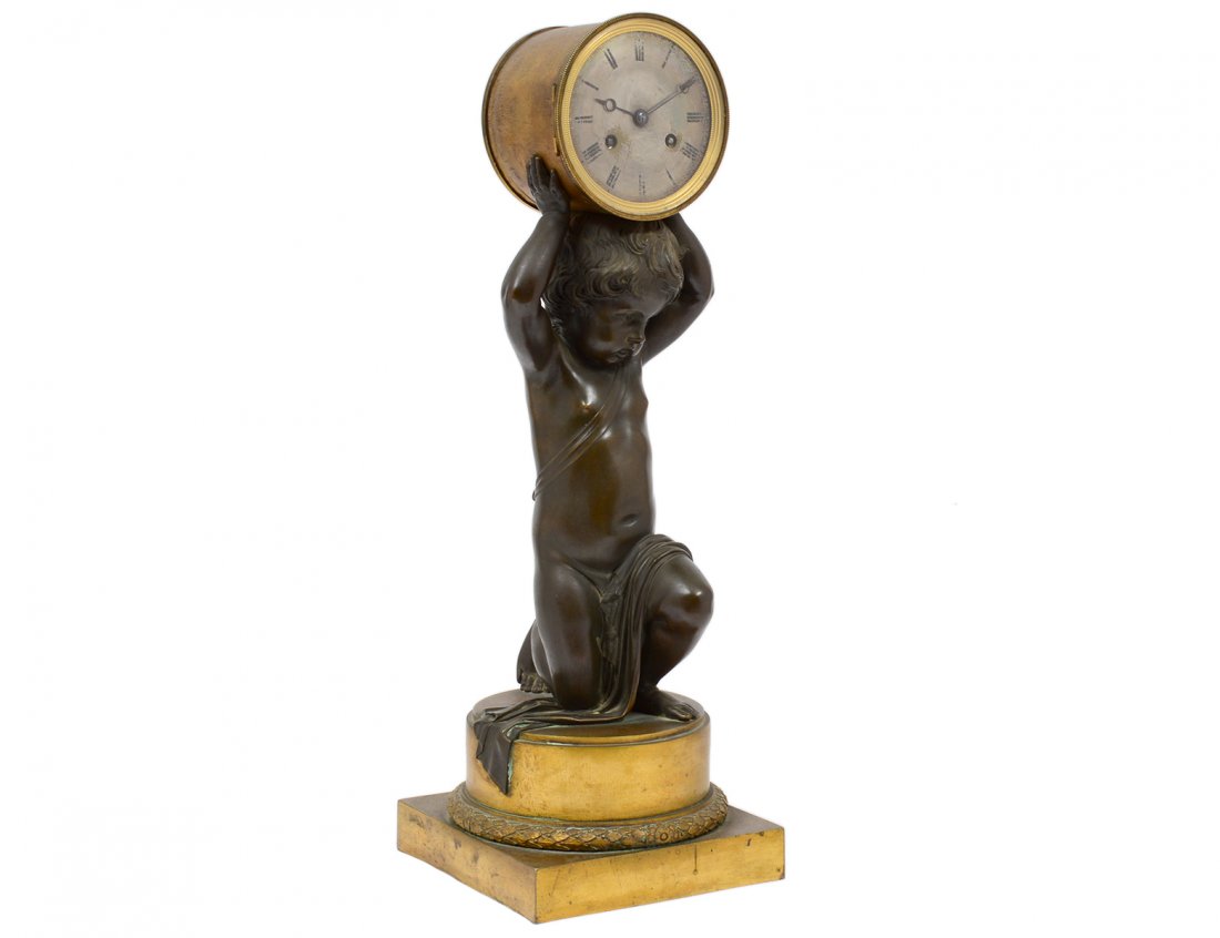 EMPIRE STYLE PATINATED AND GILT BRONZE MANTEL CLOCK: French. 19th Century. Movement stamped Breguet Neveu, No. 2835. Cast as a putto holding the clock. Height 19 3/4". (2000/3000)