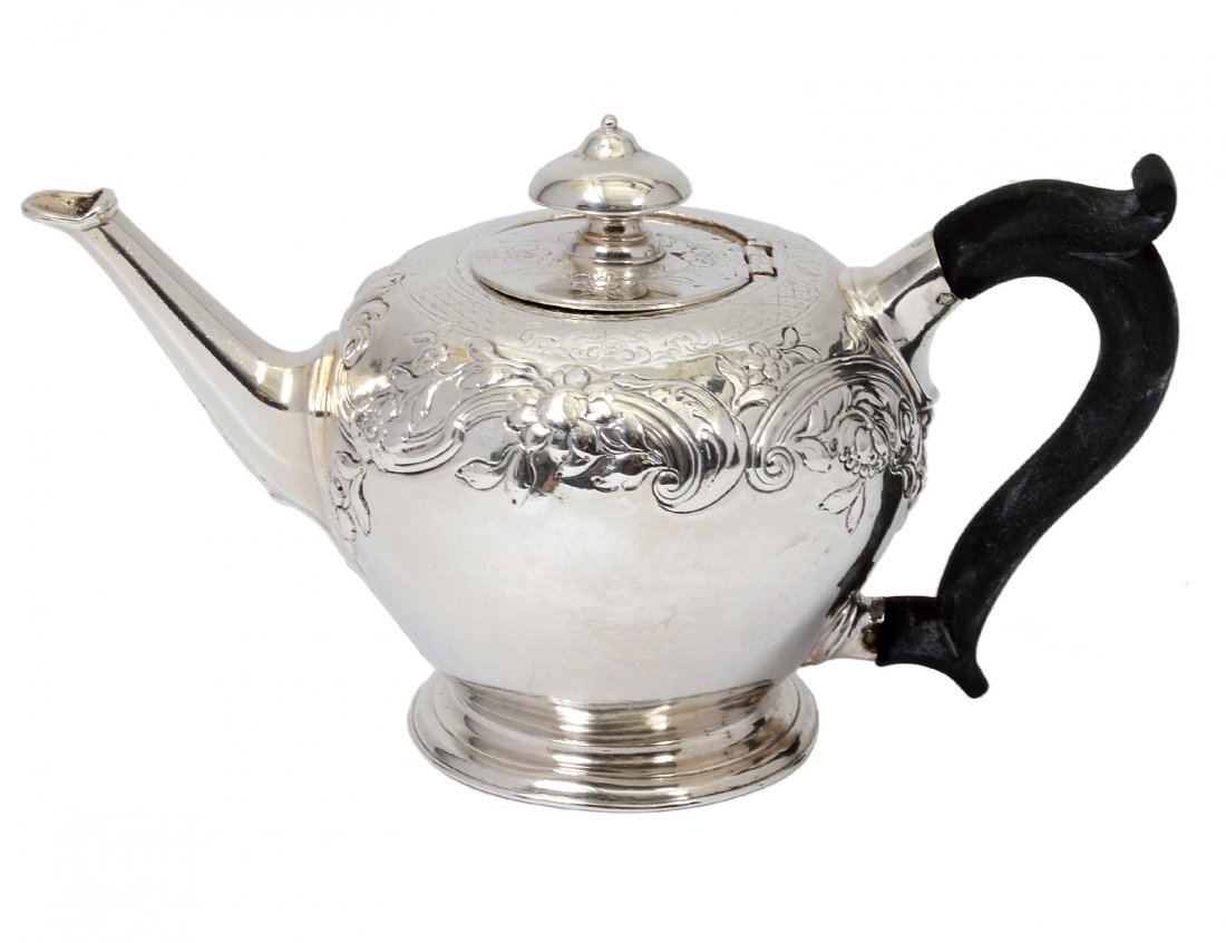GEORGE III STERLING SILVER TEA POT: English. London. Date mark rubbed. Maker: M.C. With wood handle. Height 4 1/4". (14 oz) (300/400)