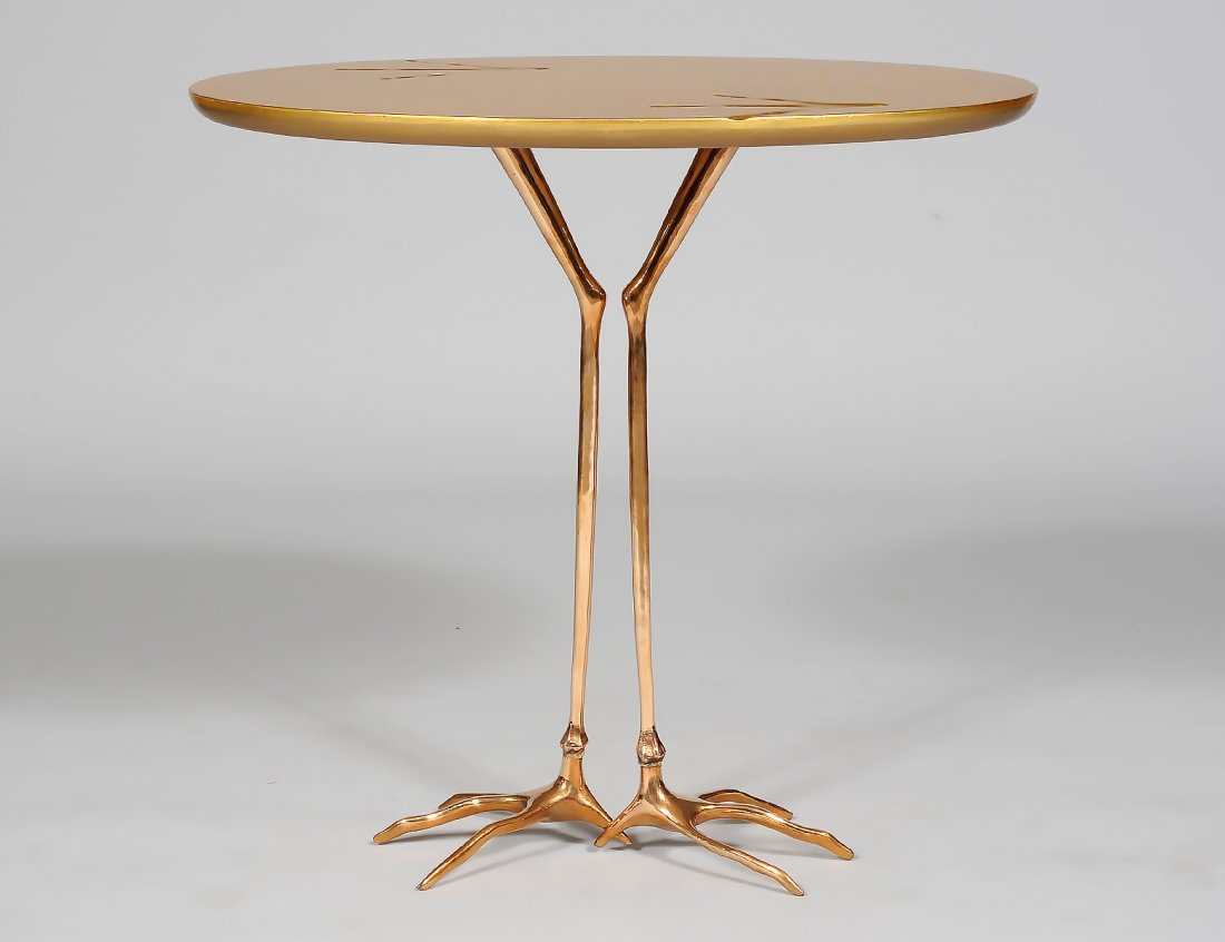MERET OPPENHEIM "BIRD LEG" BRONZE AND GOLD LEAF WOOD TA: The oval top raised on bird legs. Height 25 1/4". Width 20 3/4". Depth 26 1/2". (1000/1500)