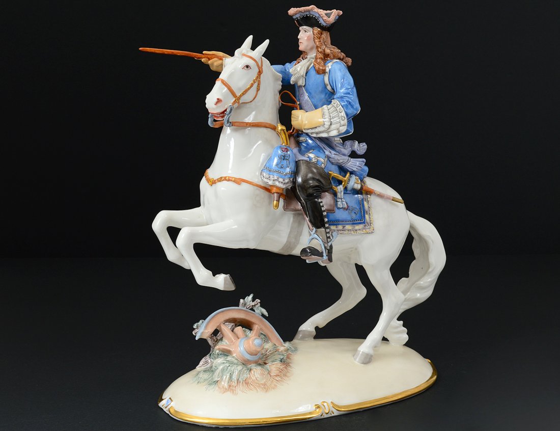 PORCELAIN FIGURE OF A PRUSSIAN HORSEMAN: German. Titled on base. Height 12 1/4". (Cond: restoration to sword) With glass dome. (250/300)