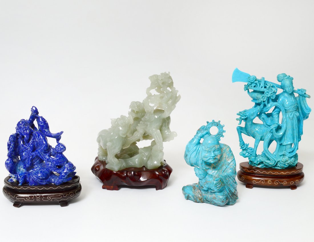 GROUP OF FOUR HARDSTONE CARVINGS: Chinese. Comprising: sodalite group, turquoise immortal, serpentine fu lions and a blue stone Guanyin with deer. Heights 3 Â¼â€ to 4 Â½â€. (200/300)