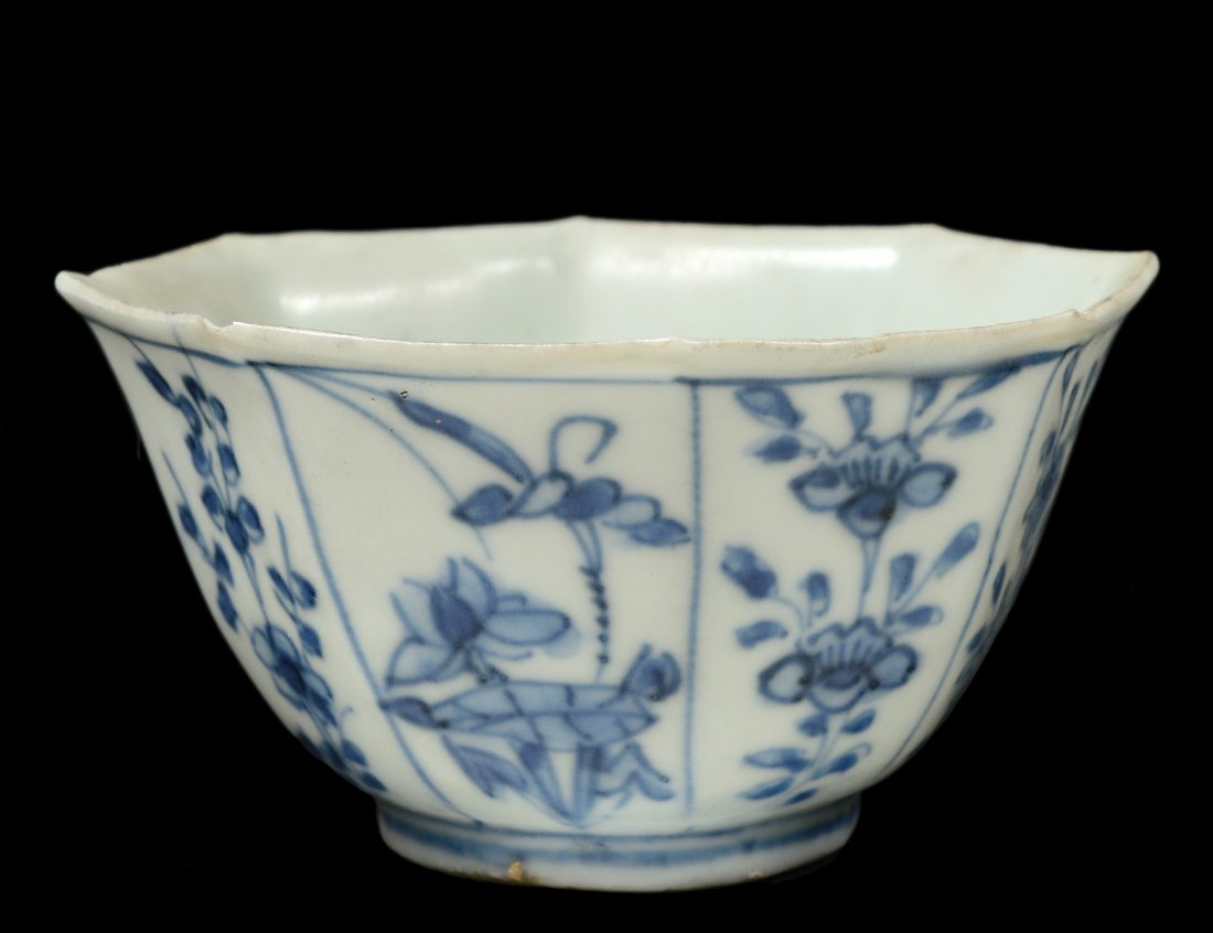 MING BLUE AND WHITE PORCELAIN RICE BOWL: Chinese. Ming Dynasty. 1368-1644. Of octagonal form, painted with blossoms. Diameter 3 1/2". (Cond: minute chip to rim) (200/300) Note: salvaged in 1984 in the South China Sea by Michael Hatacher