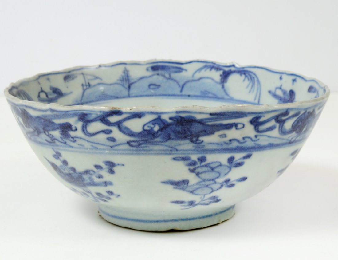 MING BLUE AND WHITE PORCELAIN BOWL: Chinese. Ming Dynasty. 1368-1644. With scalloped rim, the interior centered by a landscape. Diameter 6 1/2". (400/600) Note: salvaged in 1984 in the South China Sea by Michael Hatacher