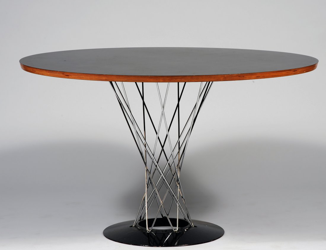 ISAMU NOGUCHI CHROME, METAL AND WOOD TABLE: With ebonized circular top. Height 28 1/2". Depth 47". (500/700)