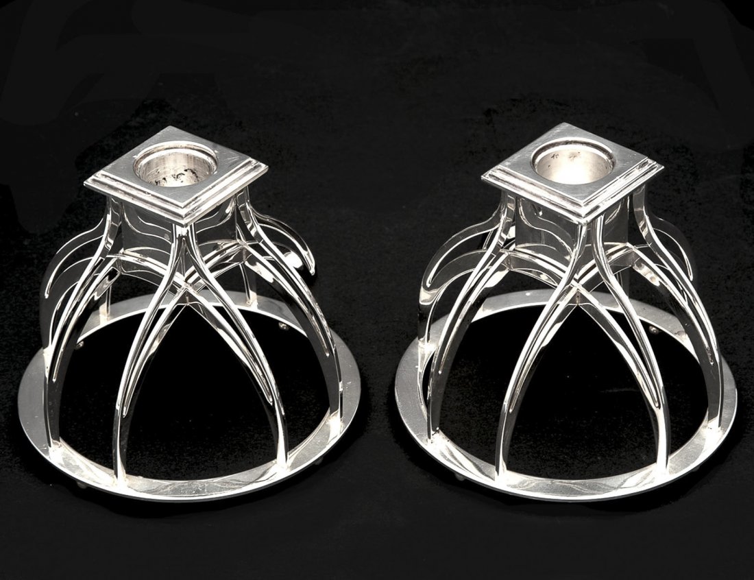 PAIR OF MID-CENTURY SILVER PLATED CANDLE HOLDERS: Italian. Maker: Alessi. The open domical base supporting the removable nozzle. Height 4 1/8". (600/800)