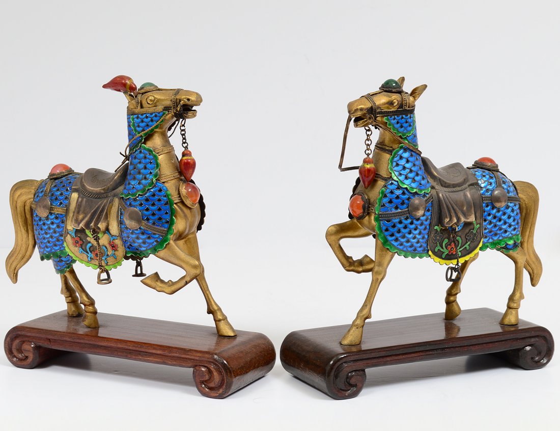 PAIR OF BRASS AND ENAMEL HORSES: Chinese. Each with saddle and decorated with cabochons. Mounted on a wood base. Height 8". (150/200)
