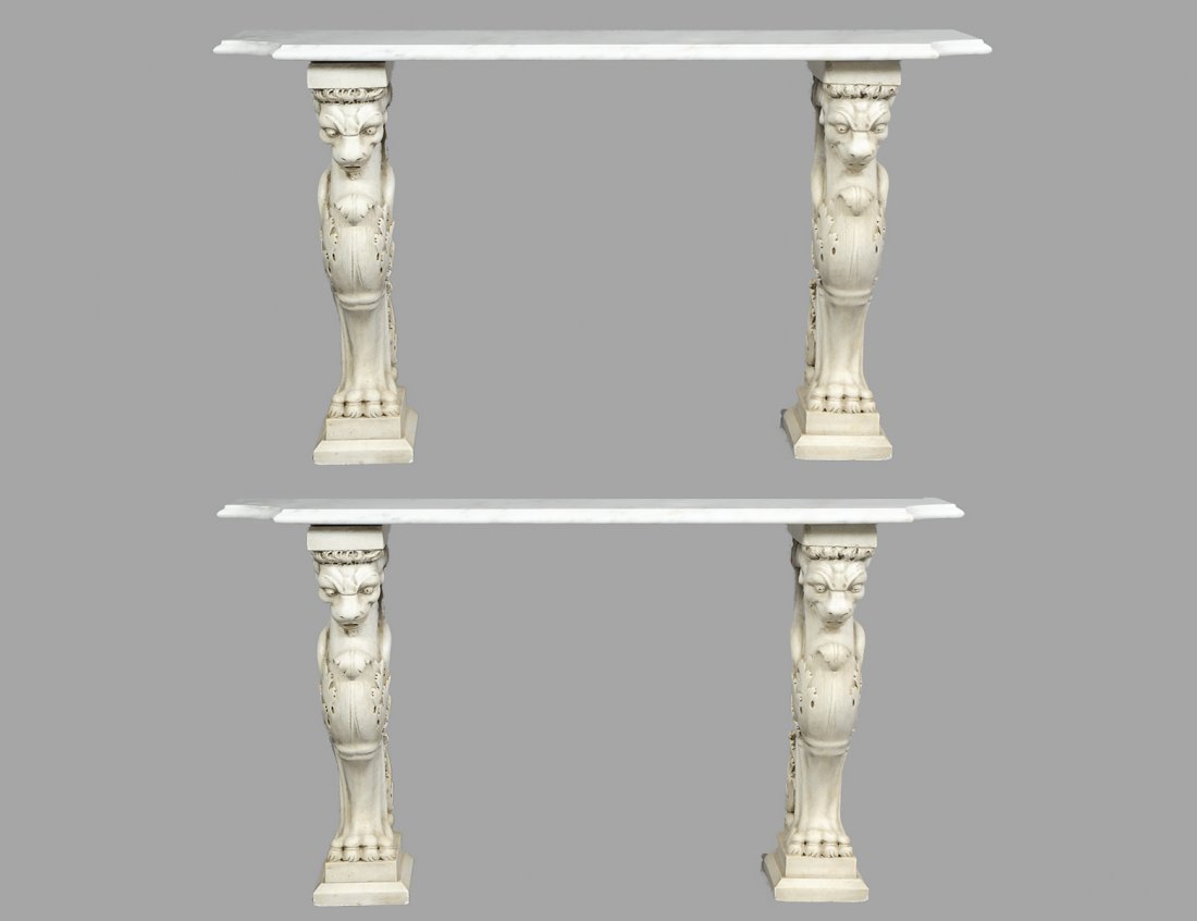 PAIR OF COMPOSITION AND MARBLE CONSOLE TABLES: Each with rectangular marble top supported by a pair of winged lion pedestals. Height 29 1/2". Width 48". Depth 15". (400/500)
