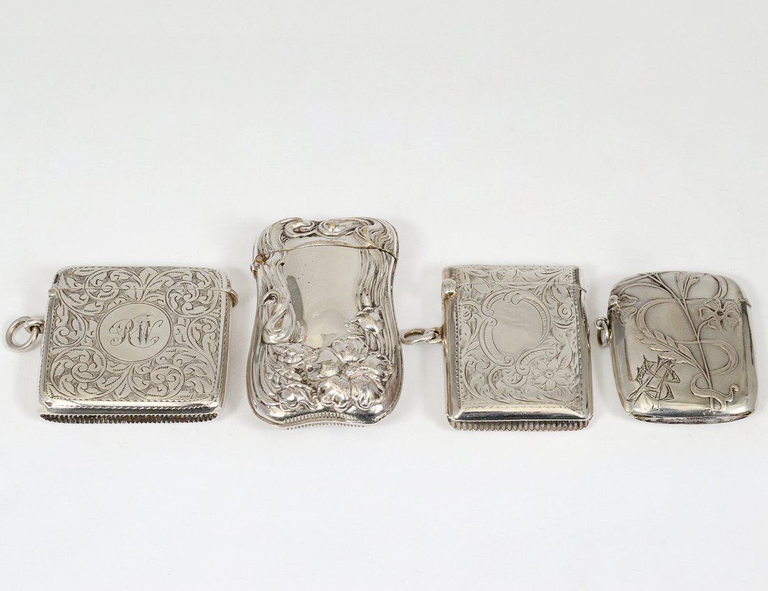 GROUP OF FOUR SILVER MATCH SAFES: English and European. Each embossed with floral design. (4 oz) (400/500)