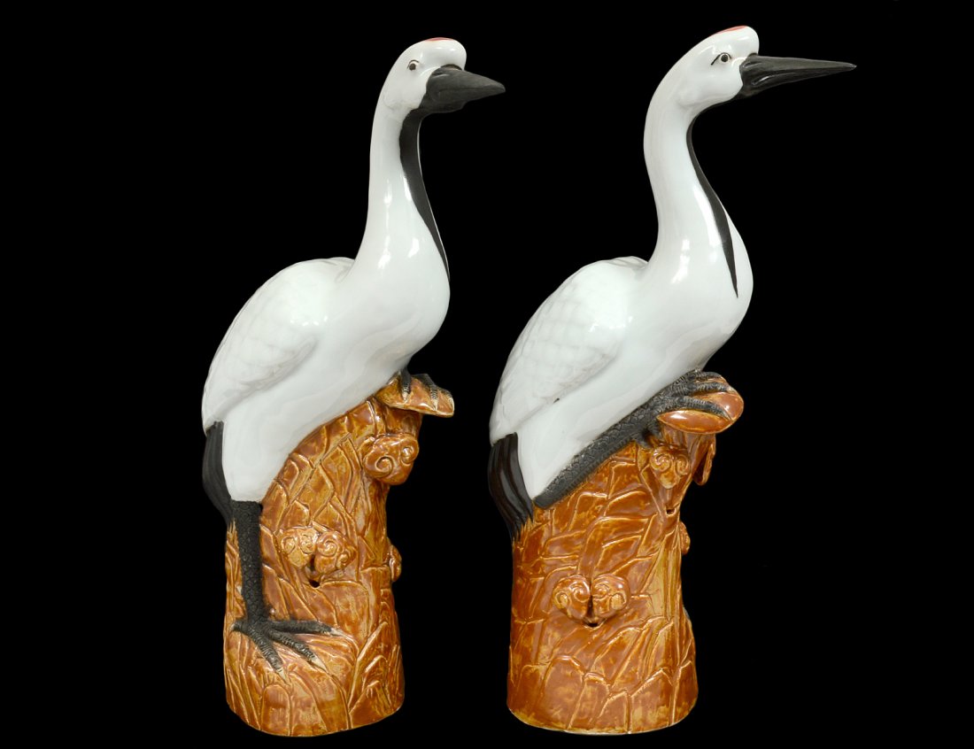 PAIR OF GLAZED POTTERY BIRDS: Chinese. Each bird modeled on a brown base. Height 15". (200/300)