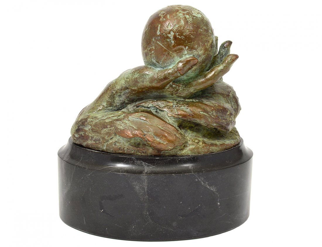 MID-CENTURY PATINATED BRONZE HAND: Indistinctly signed. Holding a ball, mounted on a marble base. Length 5 3/4". (100/150)