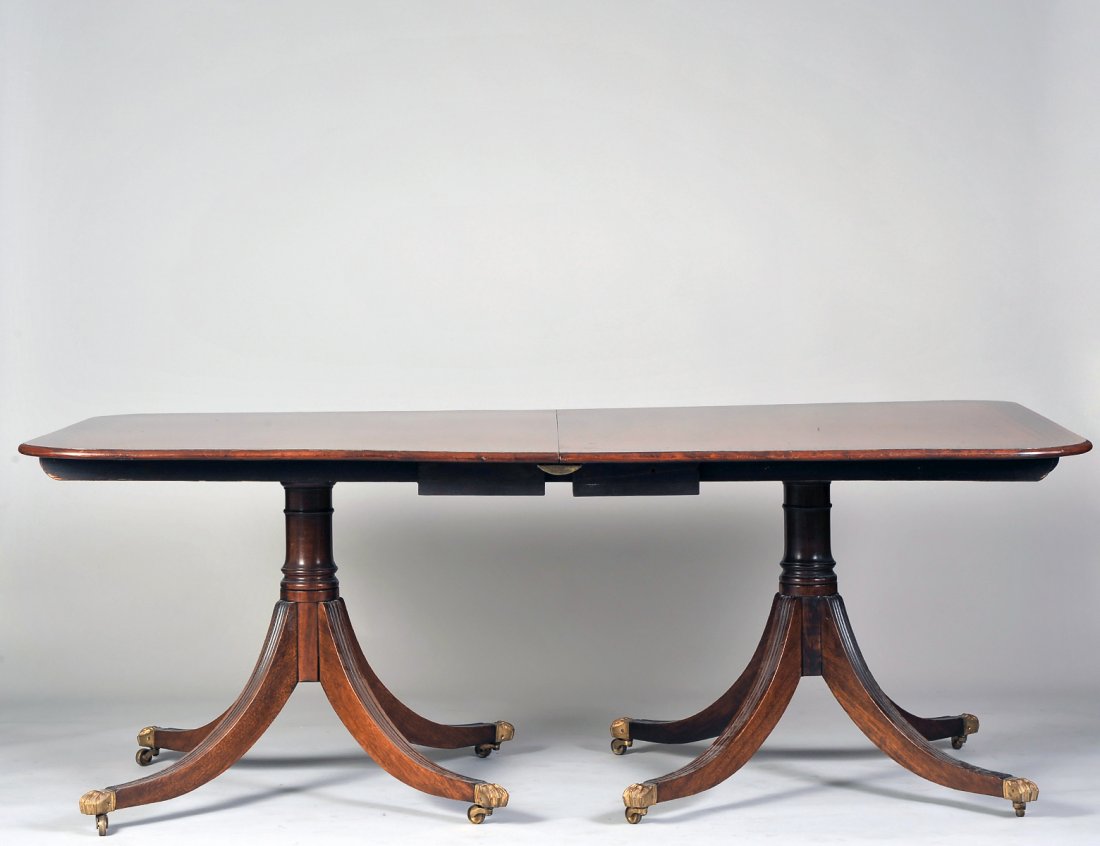 GEORGE III STYLE TWO PEDESTAL DINING TABLE: The rectangular top inlaid with Greek key border. Height 28". Width 76". Depth 44 1/2". With two extension leaves, each measuring 19 3/4". (800/1200)