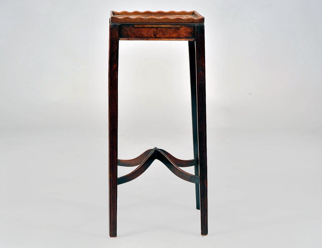 GEORGE III MAHOGANY TEA URN STAND: English. Circa 1800. The square top with scalloped gallery above a slide tablet. Height 28 1/2". Width 12". Depth 12". (300/400)