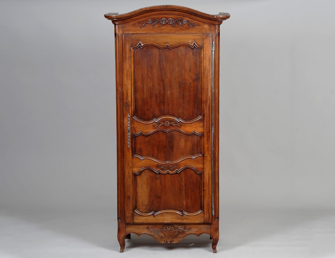 LOUIS XV PROVINCIAL STYLE BONNATIERE: French. With molded cornice above a paneled door with paneled sides, raised on short legs. Height 79 1/2". Width 37 1/4". Depth 19 1/2". (400/600)