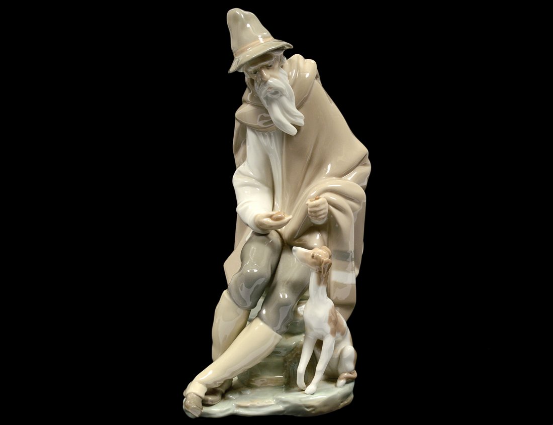 LLADRO PORCELAIN FIGURE OF AN OLD MAN WITH DOG: Spanish. Height 10 1/2". (Cond: staff missing) (100/150)