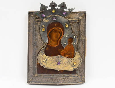 RUSSIAN SILVERED BRASS, METAL AND WOOD ICON OF OUR LADY: 17th Century. The silver gilt rizza set with amethyst, topaz and various stones. Measuring 14" by 9 3/4". (400/600)