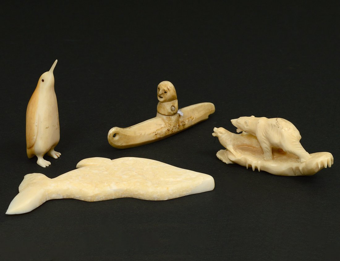 GROUP OF FOUR ESKIMO BONE CARVINGS: American. Alaska. Comprising: polar bear, whale, person in a kayak and a penguin. (50/80) NOTE: DOMESTIC AND INTERNATIONAL SHIPPING IS NOT AVAILABLE FOR THIS ITEM. This item can only be picked up from