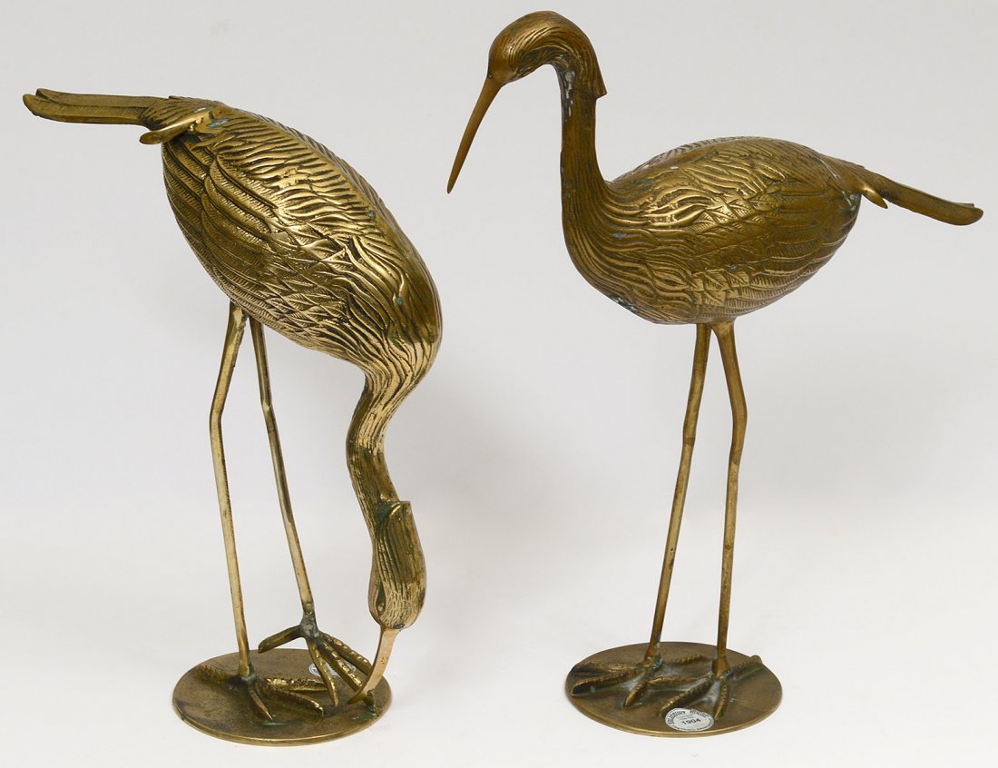 PAIR OF BRASS CRANES: One with head up and one with head down. Heights 12 1/2" and 15 1/4". (100/150)