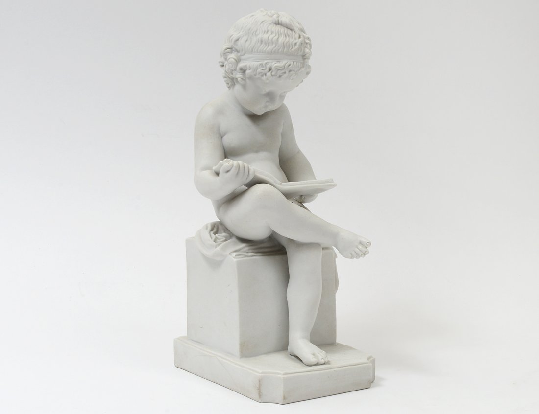 PARIAN-WARE FIGURE OF A BOY READING A BOOK: Indistinctly signed on the back. Height 11". (200/250)