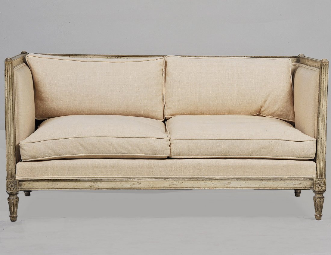 LOUIS XVI STYLE BLEECHED SETTEE: With padded backrest and arms above the seat with loose cushions, raised on short reeded legs. Length 60". (400/600)