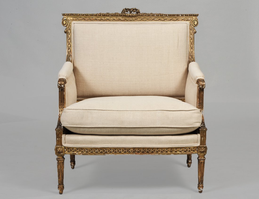 LOUIS XVI STYLE CARVED AND GILTWOOD BERGERE BY: French. Active 1878-1906. Branded on the underside. (600/800)