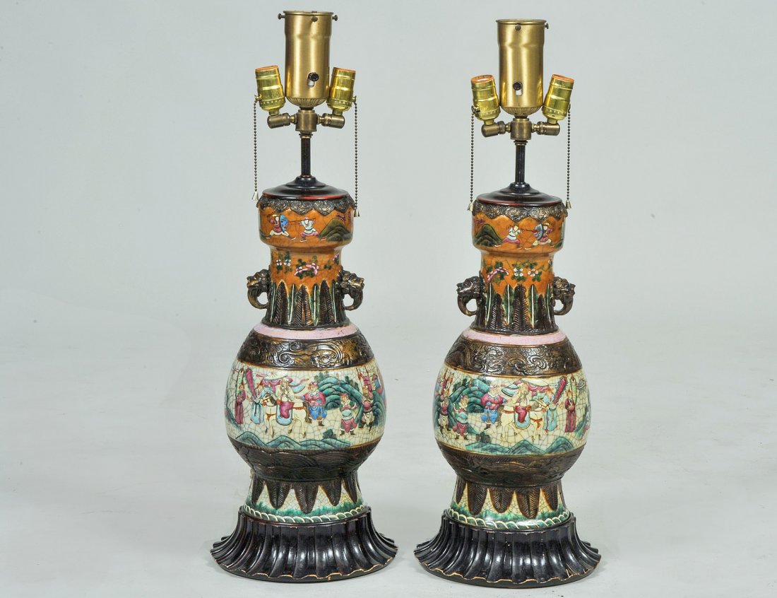 PAIR OF CARVED CRACKLE-WARE PORCELAIN VASES: Chinese. Each decorated with a continuous battle scene. Height 17". (Now mounted as lamps) (300/500)
