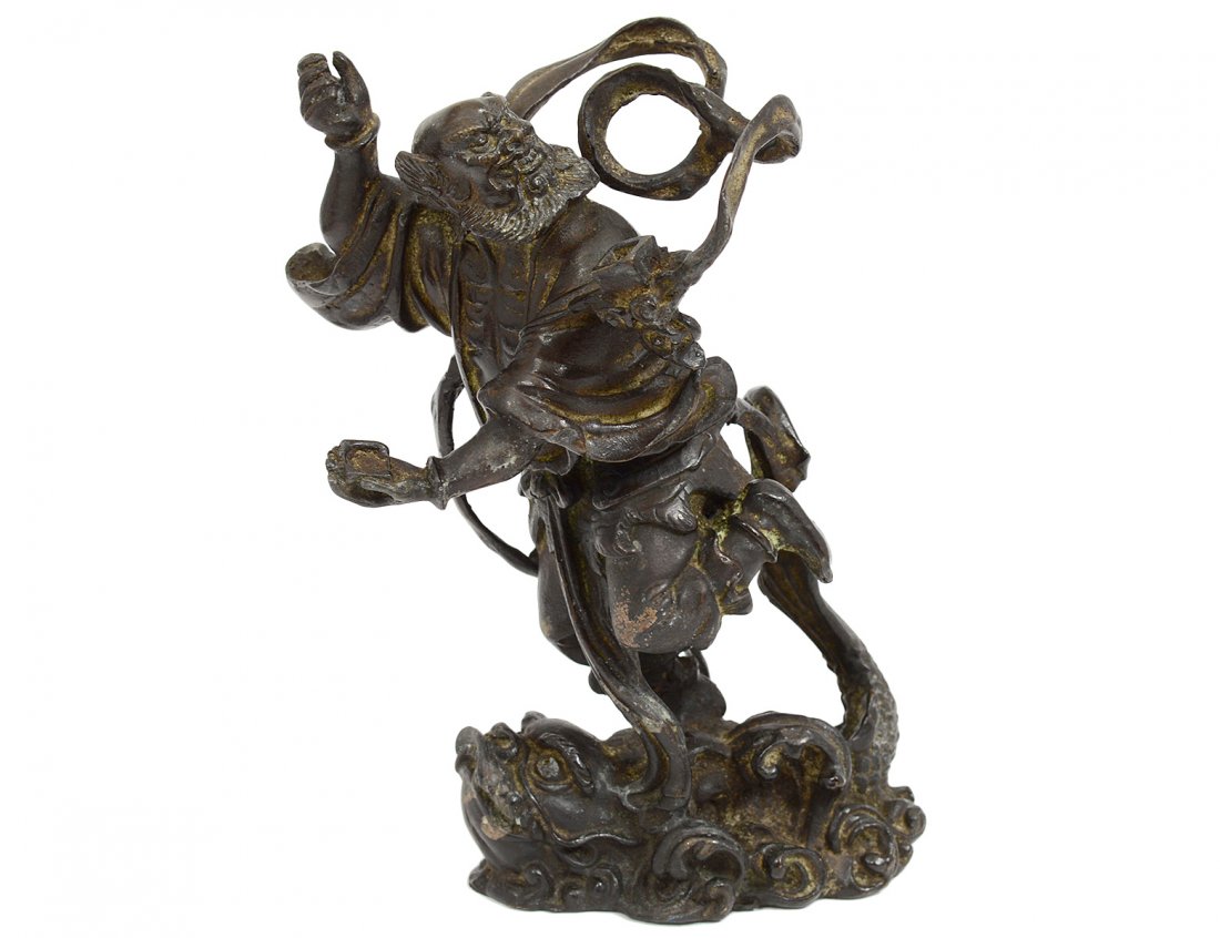 PATINATED BRONZE FIGURE OF "KUIXING": Chinese. The Daoist immortal point fighting to kick the bucket. Height 6 1/2". (800/1000)