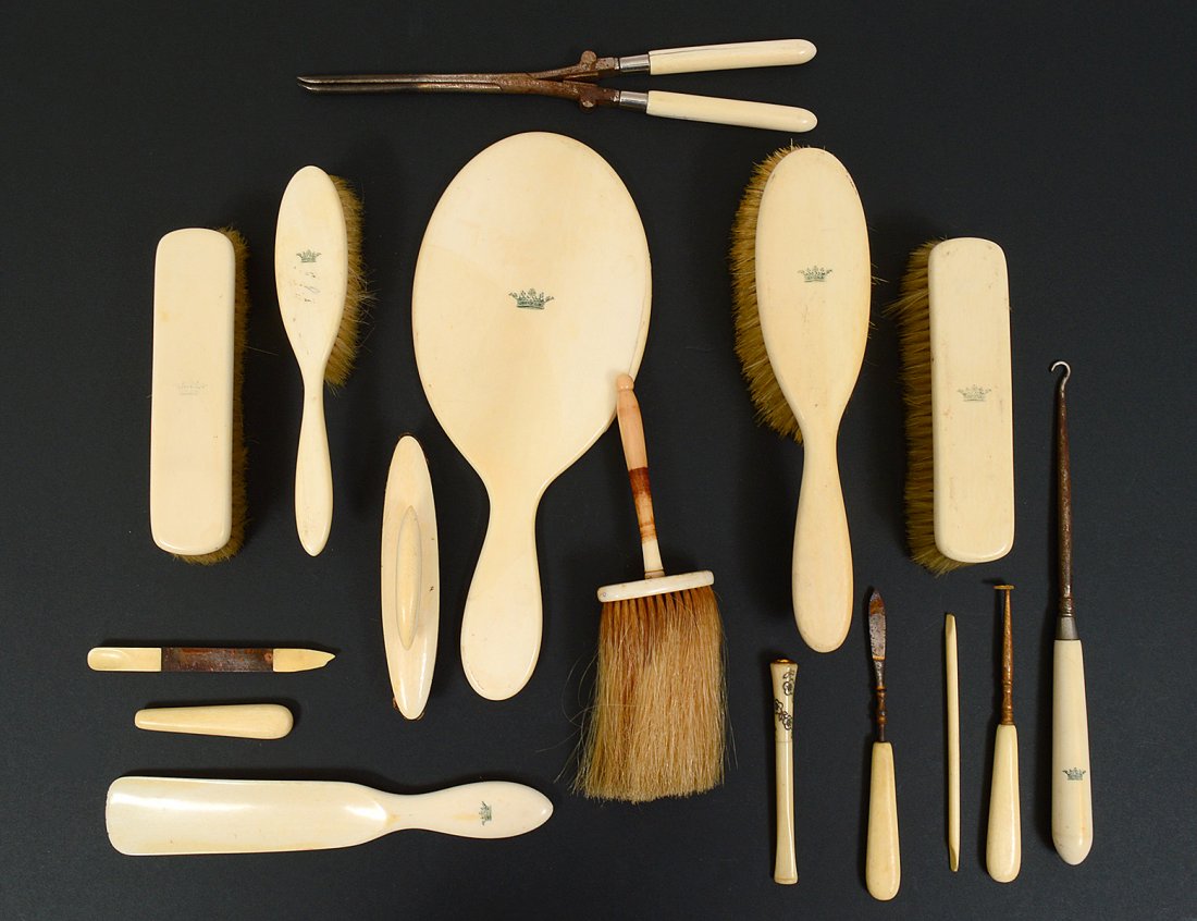 IVORINE SIXTEEN PIECE DRESSER SET: Comprising: five brushes, hand mirror, shoe horn, file and eight smaller articles. Length of longest 10". (Cond: signs of wear) (100/150)