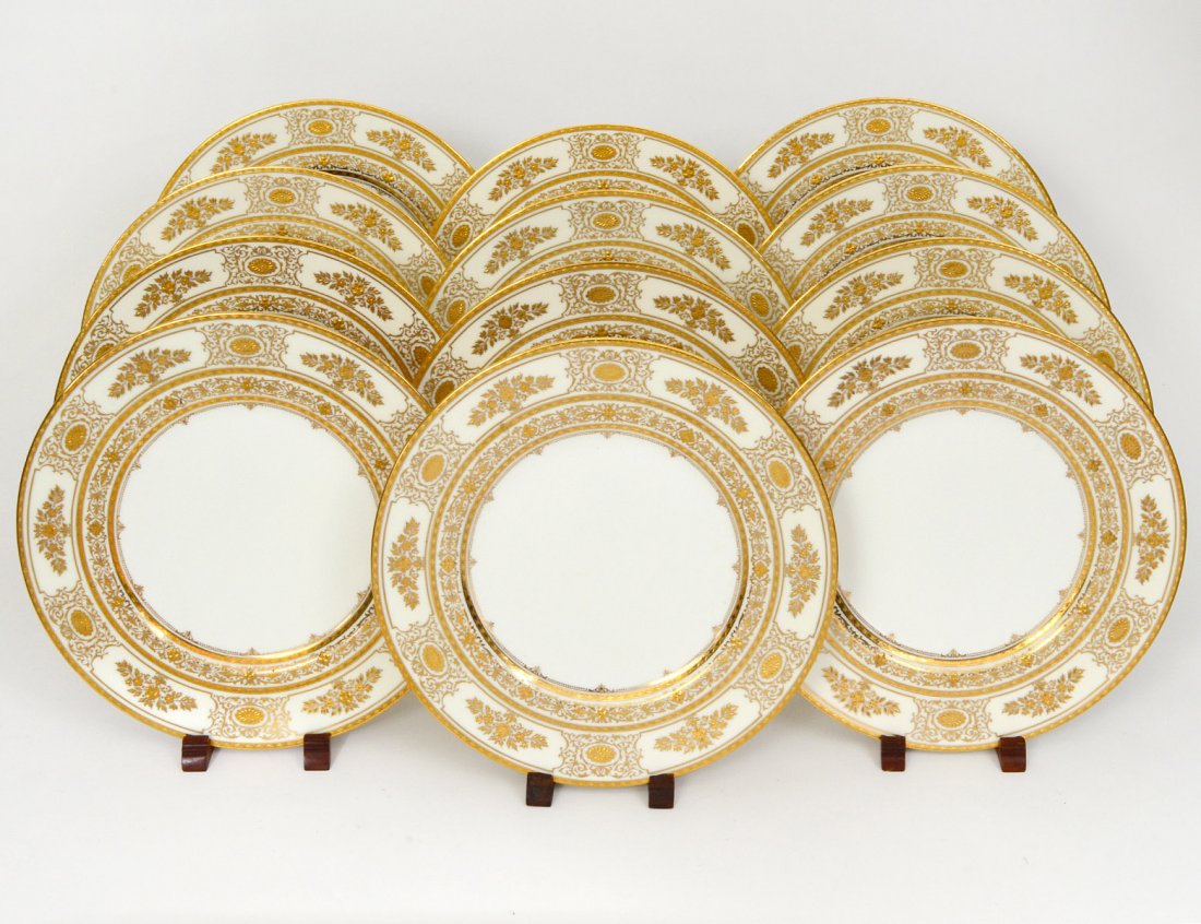 SET OF TWELVE MINTON PORCELAIN SERVICE PLATES: With gilt encrusted borders. Diameter 10 1/2". (Cond: good) (300/400) Retailed by Henry Birks & Sons.