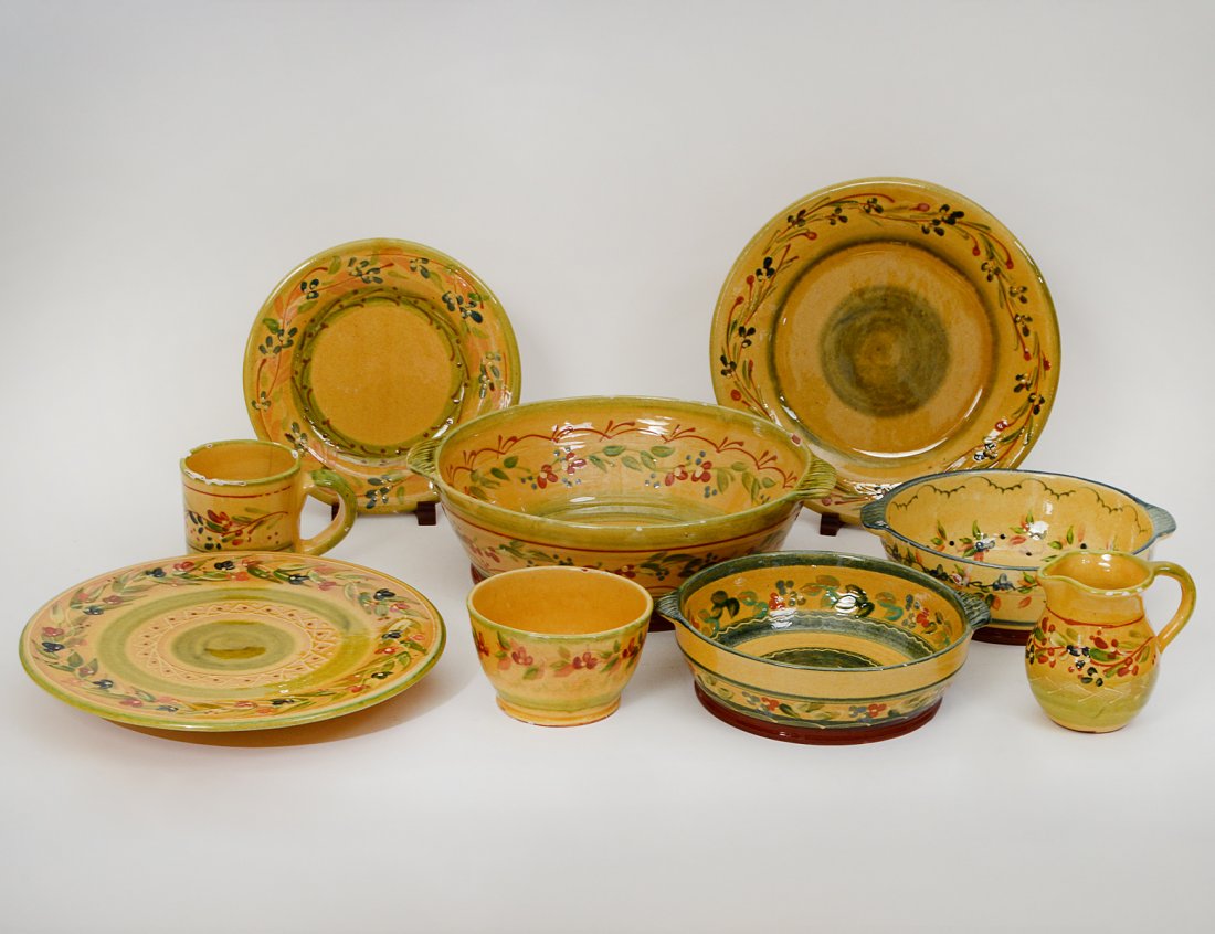 FORTY-ONE PIECE FRENCH PROVINCIAL FAIENCE PART TABLE: Modern. Impressed with various marks. Painted with flowers on a mustard ground. Comprising: 9 dinner plates, 12 lunch plates, 6 large bowls, 4 further bowls, 2 small bowls, large circular footed plate