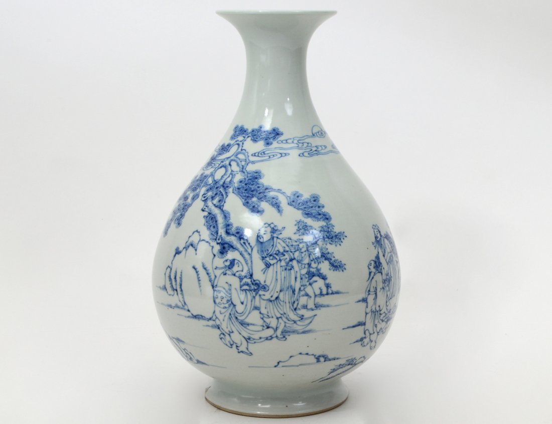 CHINESE 18TH C. PORCELAIN BLUE & WHITE VASE: Kangxi Period. The pear shape body decorated with figures and animals in a landscape. Underside with paper label from the Langsdorf Collection. Height 12". (Cond: minor firing imperfections on foot ri