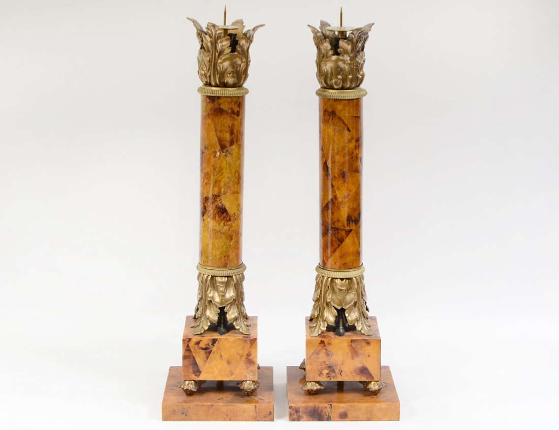 PAIR OF FAUX MARBLE TOLE PEINTE COLUMNAR CANDLE HOLDERS: Modern. Each brown veined ochre column headed and raised on brass leaves, above a double squared plinth with grape cluster feet. Height 26 in. (approx.) (Cond: good) (250/300)