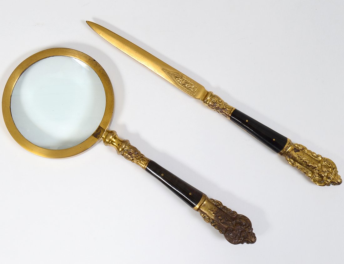 GILT METAL AND WOOD DESK SET: Modern. By Andrea Sedak. The letter opener and looking glass, in a fitted case. Length of letter opener 10 ¼”. (Cond: good) (50/75)