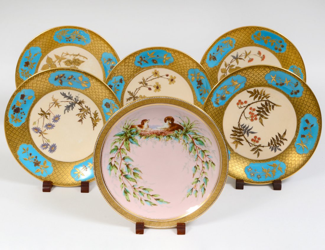 SIX ENGLISH AESTHIC MOVEMENT BLUE AND GOLD PLATES: Circa 1880. Marked on the underside “Retailed Theodore Storr, NY”. Each with a floral spray in silver and gold, with light blue border reserves. Diameter 9 ½”. (Cond: one broken, now repaired, 