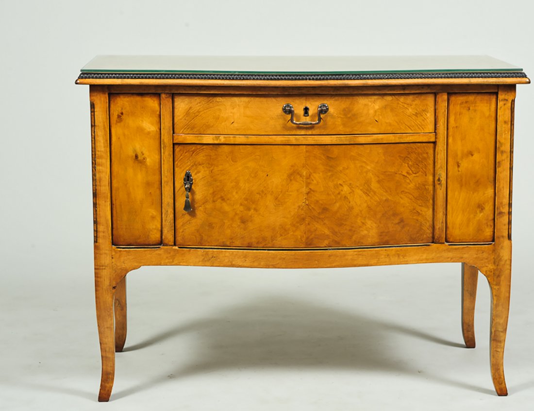 BIEDERMEIER MAPLE SIDE CABINET: German. 19th Century. With serpentine fronted beaded top above a frieze drawer and a cupboard door, raised on shaped legs. Height 29 1/4". Width 38 1/2". Depth 19". (100/150)