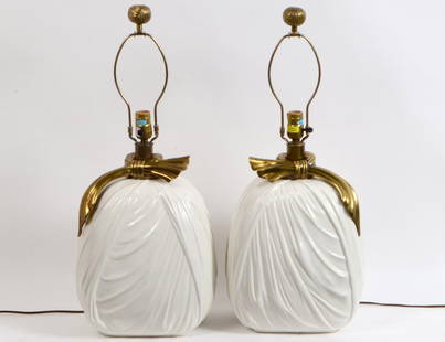 PAIR OF CHAPMAN ‘HOLLYWOOD REGENCY’ CERAMIC & BRASS: Circa 1980. Chapman Manufacturing Company. The ceramic bodies modeled as a bundled sack, with a brass sash, with brass knot finials. Height 15”. Overall 27 “. (Cond: good) (150/200)