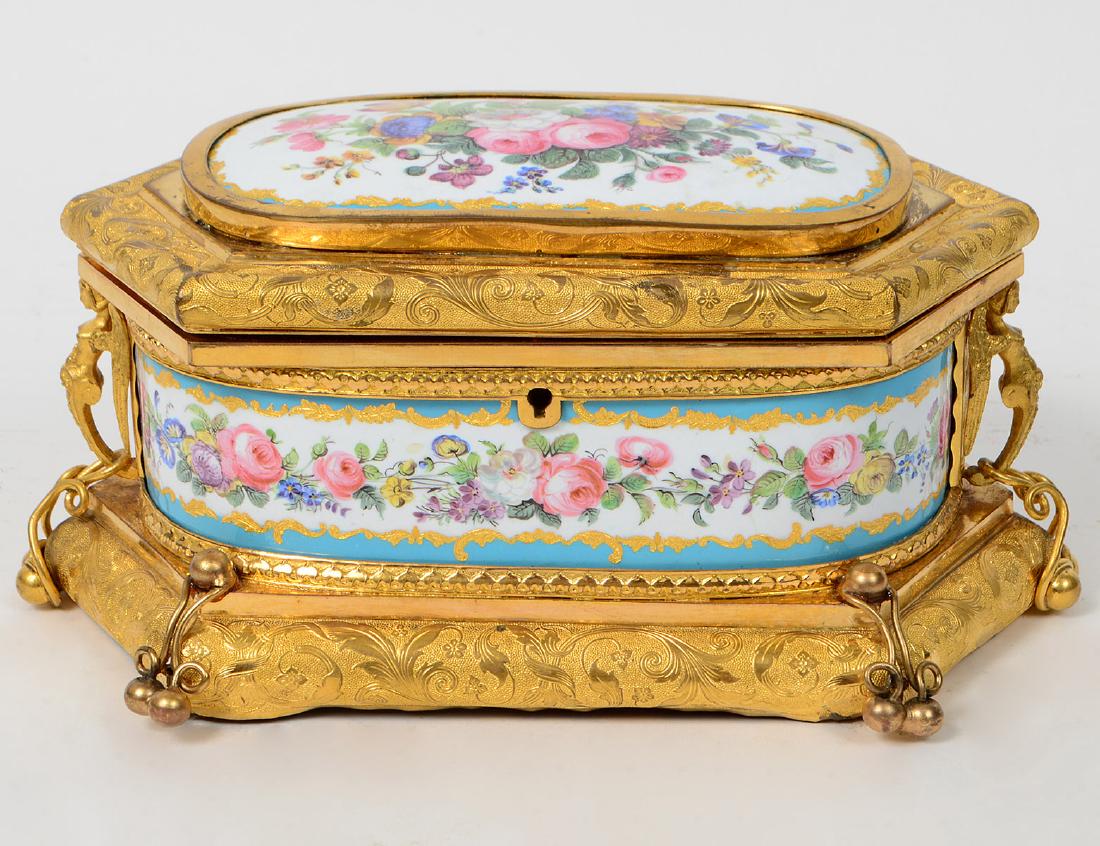 LOUIS PHILIPPE PORCELAIN & GILT METAL CASKET: Third Quarter of the 19th Century. Probably Paris Porcelain. Fitted with floral decorated plaques, the body with leaf tips and rounded borders chased with scrolling vines on a stippled ground, the sid