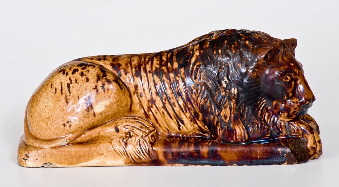 Unusual Rockingham-Glazed Lion Figure, Haig Pottery,: Rockingham Figure of a Lion, Marked "H", attributed to the Haig Pottery, Philadelphia, PA, circa 1871-1881, molded figure of a reclining lion on oblong base with surface decorated with streaked reddis