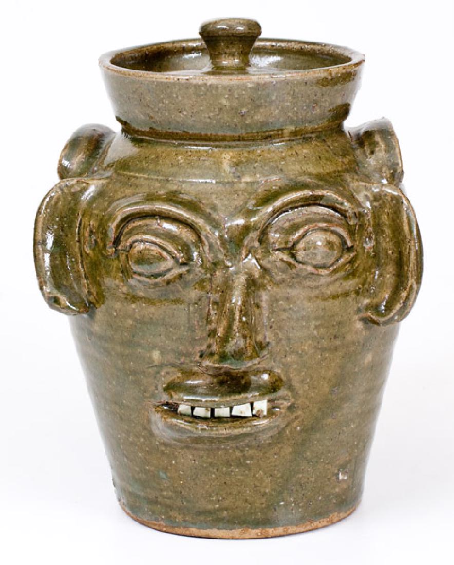 B. B. CRAIG / VALE, NC Lidded Stoneware Face Vessel: Alkaline-Glazed Stoneware Face Jar with Lid, Stamped "B.B. CRAIG / VALE, N.C.", early fourth quarter 20th century, ovoid jar with tooled shoulder, tall collar, and applied lug handles, the front featu
