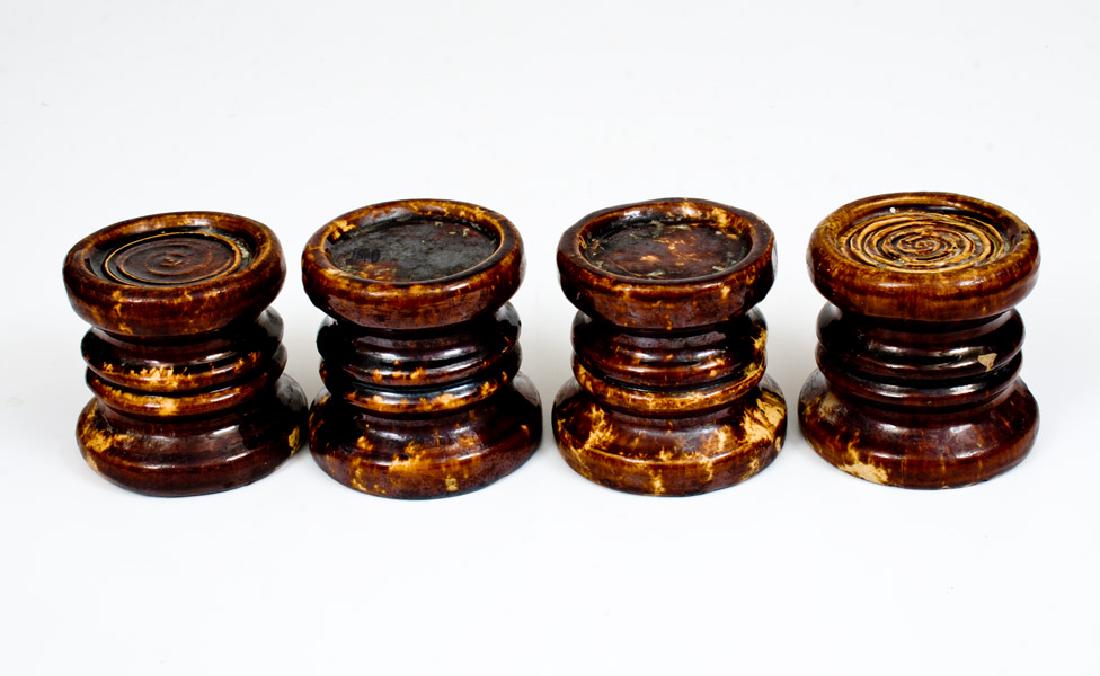 Lot of Four: Rockingham Ware Furniture Lifts: Four Rockingham Furniture Lifts, American, 19th century, each of cylindrical form with raised moldings, decorated with reddish-brown streaks over a cream-colored ground and covered in a clear lead gla