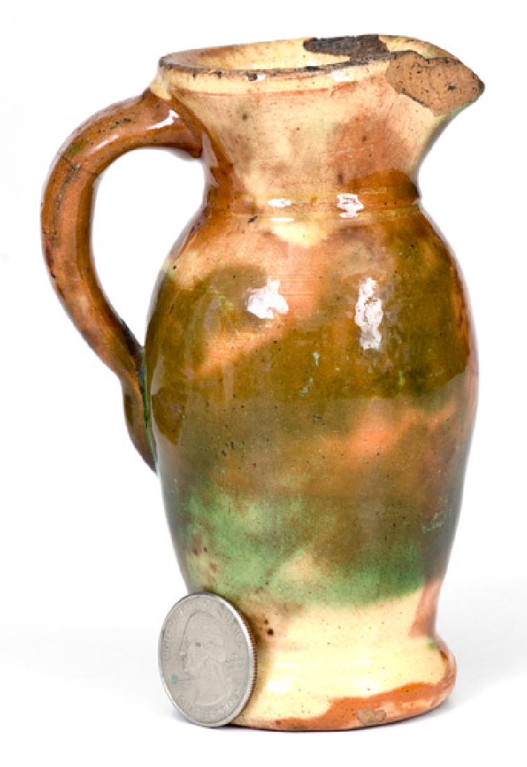Fine Miniature Multi-Glazed Redware Pitcher, Strasburg,: Shenandoah Valley Miniature Redware Pitcher, Strasburg, VA, circa 1890, ovoid pitcher with footed base and flared collar, the surface decorated with shades of cream, green, and brown and covered in a